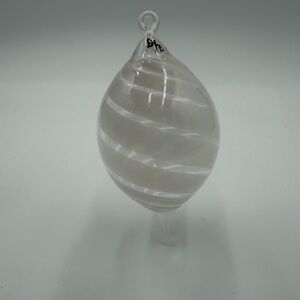 Vintage hand-blown glass ornament with a white swirl design